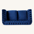 Front | Navy-blue velvet button-tufted rolled-arm loveseat on a clean warm-white studio ground