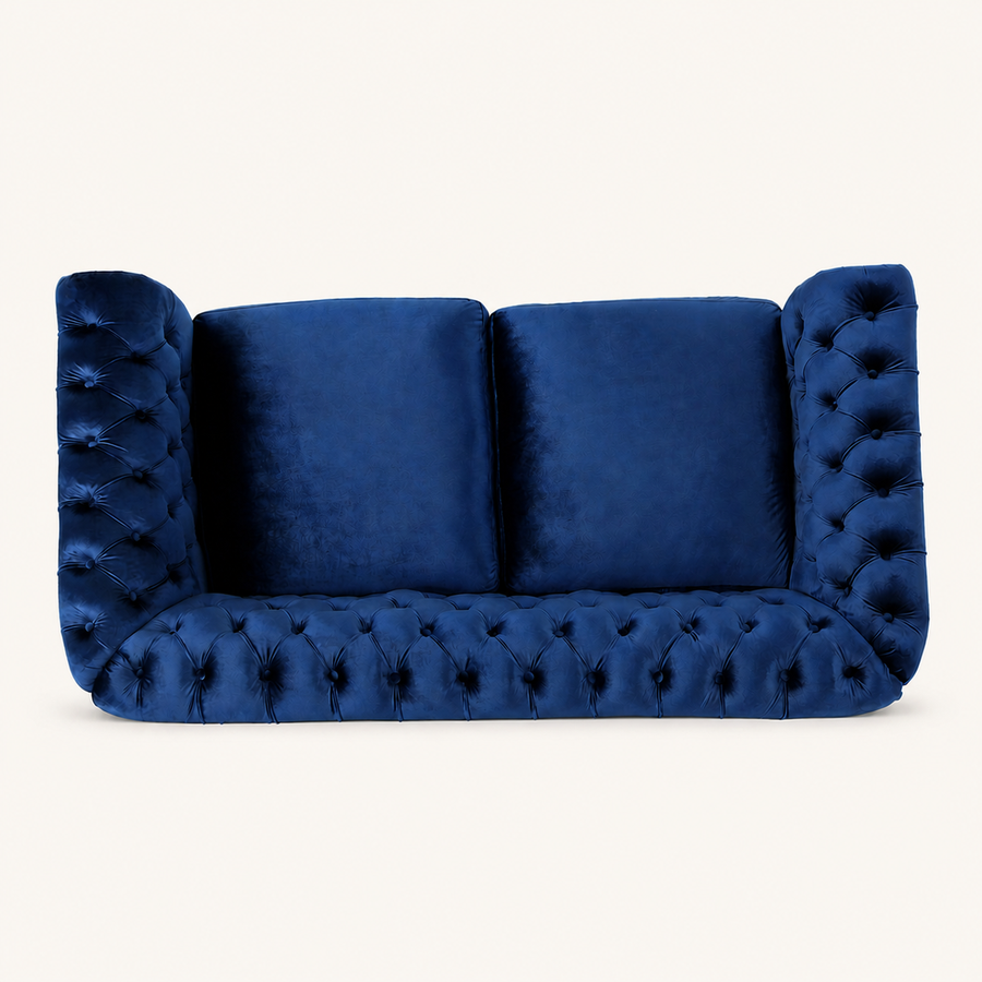 Front | Navy-blue velvet button-tufted rolled-arm loveseat on a clean warm-white studio ground