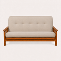 Front | Linen stone futon straight on in an off-white studio, with five back tufts, amber Barbados wood and three-slat arms