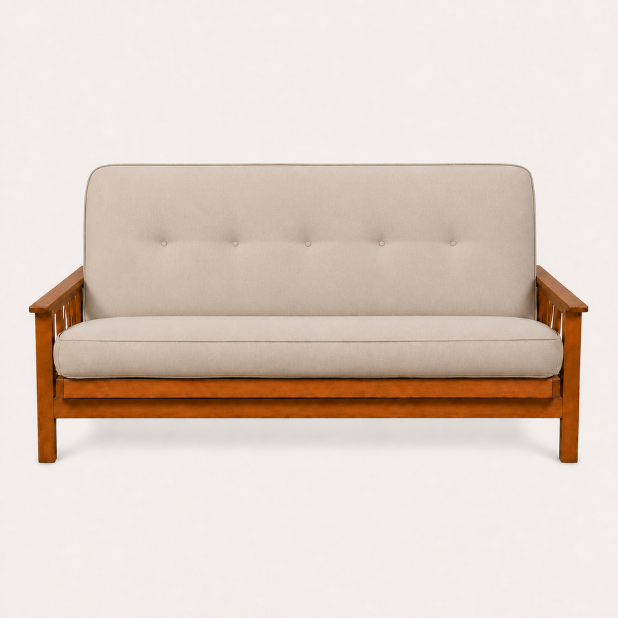 Front | Linen stone futon straight on in an off-white studio, with five back tufts, amber Barbados wood and three-slat arms