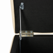 Hinge close-up | Silver hinge hardware against the black-lined storage compartment