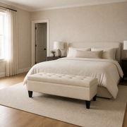 Bedroom scale | Beige storage bench at foot of bed with full-height doorway in view