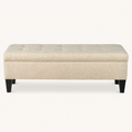 Studio front | Beige rectangular storage bench with button-tufted lid and four dark tapered legs