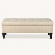 Studio front | Beige rectangular storage bench with button-tufted lid and four dark tapered legs