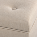 Upholstery close-up | Beige woven polyester with fabric-covered button tuft and tone-on-tone lid seam