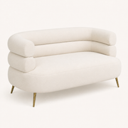 Studio | three-quarter studio view of a cream-beige velvet loveseat showing rounded roll ends and gold legs