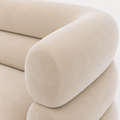 Texture | detailed view of cream-beige velvet at the rolled arm with curved seams