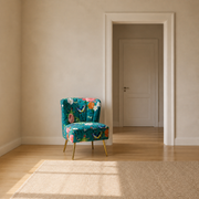 In scale | teal-blue floral velvet armless slipper chair beside an uncropped full-height doorway