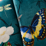 Texture close-up | teal velvet pile, channel seam, flowers, butterfly, and dragonfly fill the frame