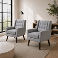 Room angle | pair of gray tufted armchairs in a cool ivory city room from a right-front angle