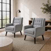 Room angle | pair of gray tufted armchairs in a cool ivory city room from a right-front angle