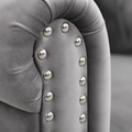 Detail | Extreme close-up of silver nailhead trim set into the light gray velvet rolled arm