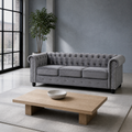 Room | Light gray velvet Chesterfield sofa in a blue-gray loft with tall steel windows and a light oak coffee table