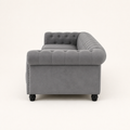 Studio | Right-side rear profile showing the rolled arm, side nailhead trim, back, and black turned legs