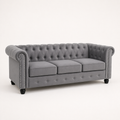 Studio | Front-left three-quarter view showing the rolled arm, nailhead trim, three cushions, and deep diamond-tufted back