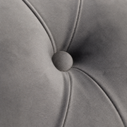 Texture | Extreme close-up of the light gray velvet tuft, fabric-covered button, and stitched diamond seams