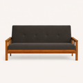 Front | Straight studio view of the charcoal-gray futon, with its button-tufted back, low wood rail, and both slatted arms