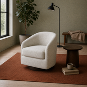 Room angle | oatmeal swivel chair at three-quarter view on a rust rug in the sage reading room