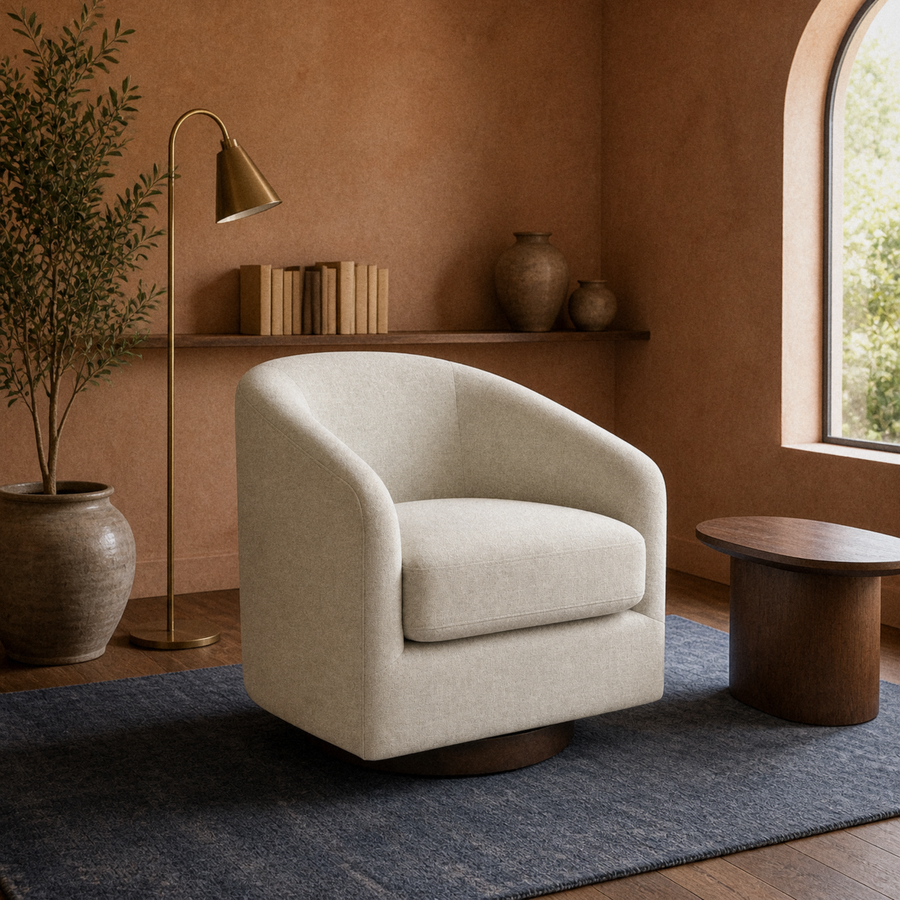 Warm room | oatmeal swivel chair on a faded indigo rug in a terracotta garden room with arched window