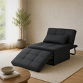 In a room | dark charcoal convertible chaise reclined with its matching ottoman cushion and bolster pillow in a warm living room