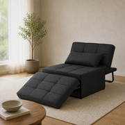 In a room | dark charcoal convertible chaise reclined with its matching ottoman cushion and bolster pillow in a warm living room