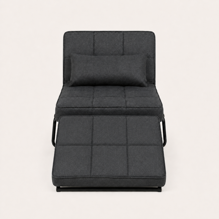 Front | front studio view of the dark charcoal convertible chaise reclined with its matching ottoman cushion and bolster pillow