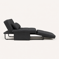 Side | side studio view of the dark charcoal convertible chaise with its black bent-metal support frame visible