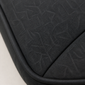 Texture | close-up of the dark charcoal woven upholstery, tonal linear motif, stitched seam, and black piping