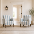 Scale | two striped armchairs beside a full-height doorway for scale