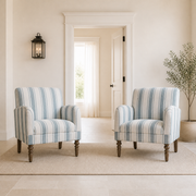 Scale | two striped armchairs beside a full-height doorway for scale