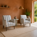 In a room | two striped armchairs in a terracotta sunroom beside an open garden doorway