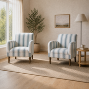 Second warm farmhouse room angle showing both matching striped armchairs