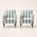 Front | straight-on studio view of two matching arched armchairs with recessed arms and dark turned legs