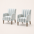 Studio | three-quarter studio view of the two arched striped armchairs showing their side depth and turned legs