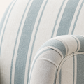 Texture | close-up of the pale blue and ivory striped polyester weave and rounded upholstered arm seam