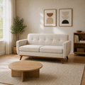 Room | Beige linen loveseat in a light-filled living room with oak furnishings and artwork