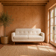 Room | Beige linen loveseat in a sunlit terracotta room with beamed ceiling and French doors