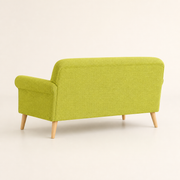 Studio side | vivid lime-green loveseat from the rear left showing the upholstered back and birch legs