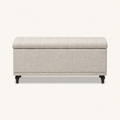 Studio front | warm beige patterned polyester storage ottoman with tufted lid, channel stitching, silver nailhead trim and dark turned legs