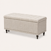 Studio three-quarter | warm beige patterned storage ottoman showing its tufted lid, long front, right end and silver nailhead trim