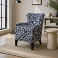 In a room | three-quarter view of the patterned club chair in the cool ivory room with pale oak flooring