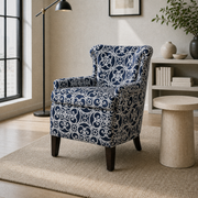 In a room | three-quarter view of the patterned club chair in the cool ivory room with pale oak flooring