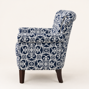Side | right-rear studio profile showing the upholstered outer back, rolled crest, side panel, and curved rear leg