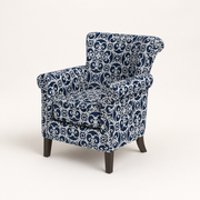 Angle | three-quarter studio view showing the chair depth, patterned side panel, nailhead trim, and wood legs