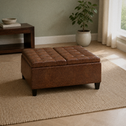Room | closed umber-brown faux leather ottoman on a plain oatmeal rug in a sage-green living room