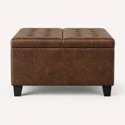 Studio back | back elevation of the square umber-brown faux leather ottoman with smooth panel and two tapered legs on a warm-white ground