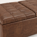 Texture detail | close view of distressed umber-brown faux leather grain, tufting, and raised seams