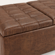 Texture detail | close view of distressed umber-brown faux leather grain, tufting, and raised seams