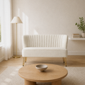 In a room | ivory velvet channel-tufted armless loveseat with gold hairpin legs in a warm-white living room
