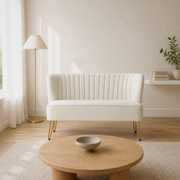 In a room | ivory velvet channel-tufted armless loveseat with gold hairpin legs in a warm-white living room